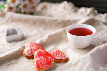 Heart shaped red hand made cookies and hibiscus tea.
