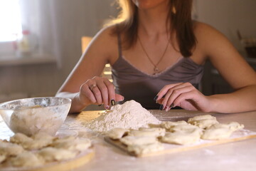 Girl makes dumplings with potatoes and mushrooms