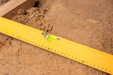Construction bubble level at the construction site, leveling the floor. House or apartment...