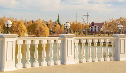 Beautiful white terrace over water in autumn city park