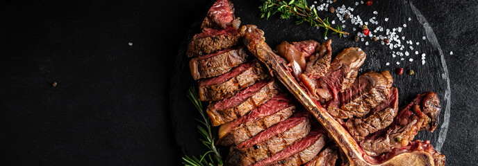 Beef T-Bone steak. Medium rare sliced grilled striploin beef steak with fork and knife. American meat restaurant. banner, catering menu recipe place for text