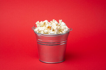 Popcorn bucket on a red background.