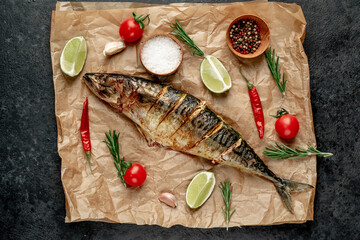 grilled mackerel with lime and spices on stone background