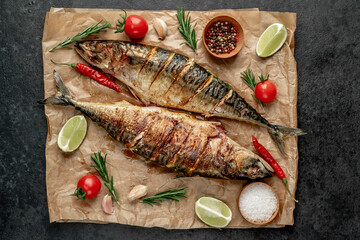 grilled mackerel with lime and spices on stone background