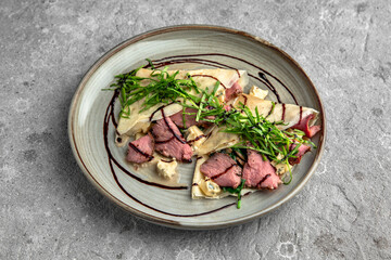 Pancakes with beef slices, Dorblu cheese, herbs and sauce. Delicious, hearty, nutritious breakfast. Balanced nutrition for beauty and health.