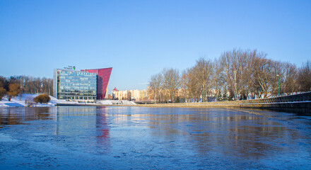 Red triangular glass building in sunny winter park