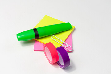 bright colorful marker, stickers, paper clip and scotch tapes on white background