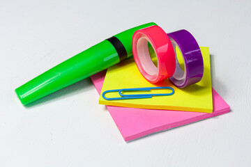 bright colorful marker, stickers, paper clip and scotch tapes on white background