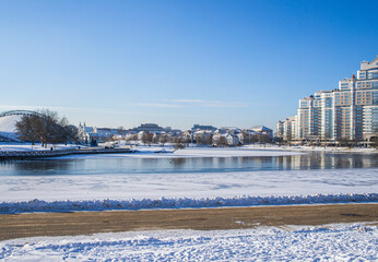 Cityscape on the city near the river on a winter sunny day