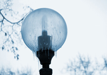 Fototapeta na wymiar icicles on a street light in winter day