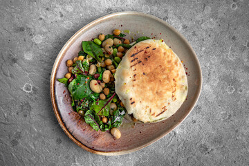 Vegetarian high protein food. Pita with boiled beans, chickpeas pasteuria and herbs.