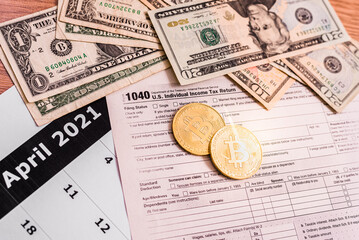 Form 1040 for 2020 with bitcoin coins to declare income generated by investments in cryptocurrencies