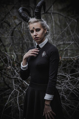 Naklejka premium Witch in the form of a student in the forest
