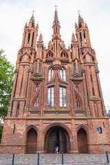 Fototapeta na wymiar Red brick St. Anne's church (1500) - Flamboyant Gothic and Brick Gothic styles Roman Catholic Church in the Old Town of Vilnius. Lithuania.