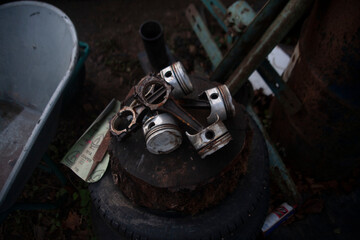detail of a car, old details of a car, car piston, engine detail, metalic engine detail outside of an engine