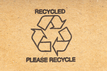 Recycle symbol on brown recycled cardboard background