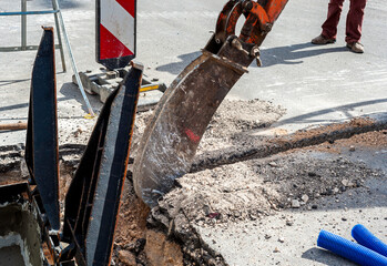 mini excavator equipped with a very narrow bucket to perform excavations of small width in the...