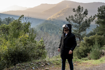 Man using virtual reality glasses outdoors. using technology in the mountains and in harsh conditions.