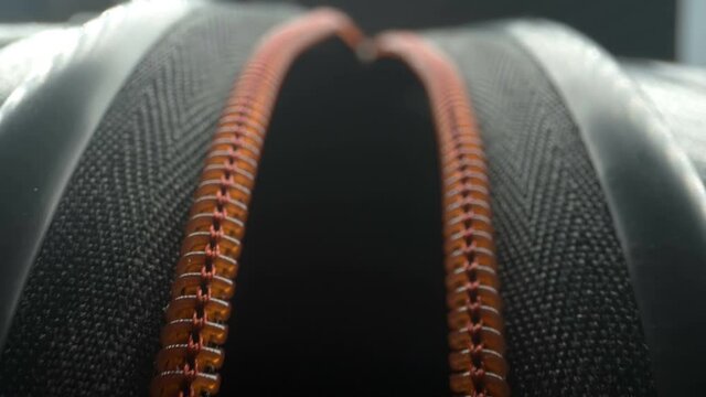 Closer look of the opening of the luggage bag with the orange zipper