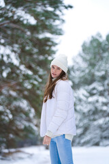 Obraz premium beautiful smiling young woman in wintertime outdoor. Winter concept