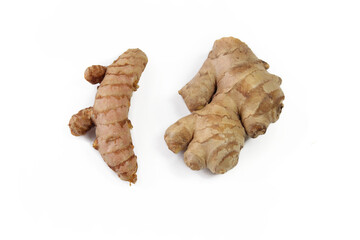 Turmeric root and ginger root on a white background