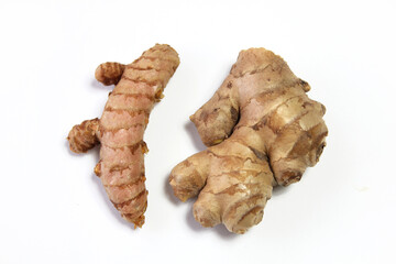 Turmeric root and ginger root on a white background