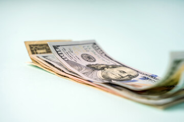 Paper money dollars lie on a blue background, selective focus and space for text