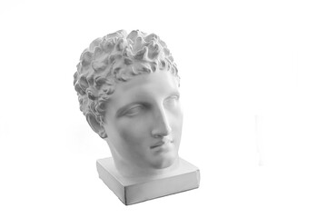Plaster statue of the head of an ancient Greek God. Plaster replica of the statue isolated on a white background. Ancient Greek sculpture, statue of a hero