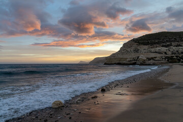 Fototapeta premium beautiful ocean sunset on the Costa del Sol in Spain with beach and cliffs in the background