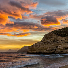 beautiful ocean sunset on the Costa del Sol in Spain with beach and cliffs in the background