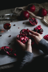 girl holding in hands a pomegranate