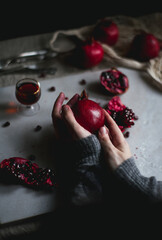 girl holding in hands a pomegranate