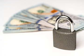 Locked lock on banknotes as a concept of financial security of deposits and money storage