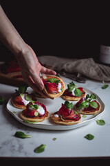 mini pancakes with beetroot gravlax on a white plate