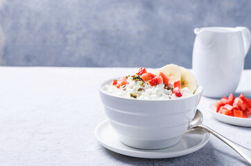 Healthy breakfast with cottage cheese and banana, flaxseed and seasonal fruits.