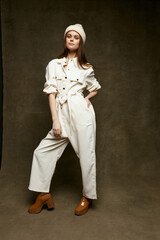 Fototapeta na wymiar Fashion Lady White Hat Jumpsuit Brown Studio Boots