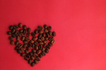 Obraz na płótnie Canvas heart of coffee beans on a pink background