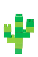 green blocks of a children's construction kit stacked in the form of a cactus on a white background