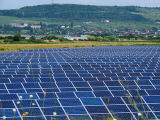 Modern ecologic solar panels power station on the meadow  in a sunny area 