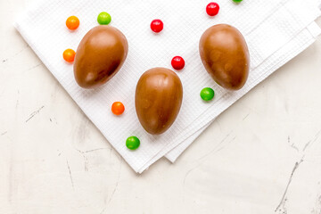 Easter chocolate eggs top view on stone background mock up