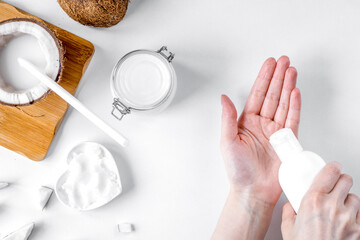 organic cosmetics with coconut on white background top view