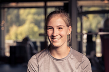 young female gym member is smiling into the camera