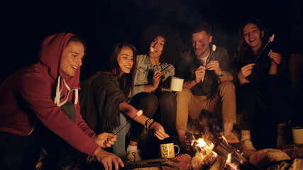Group Of Happy Friends Camping In The Woods At Night Laughing And Holding Marshmallows Nature Tourism Travel Party Concept Shot On Red Epic W