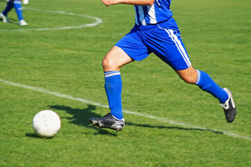 soccer player kicking ball