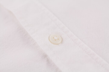 button on a white men's shirt close up