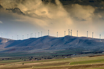 Fototapeta na wymiar Wind turbines energy farm, green ecological power energy generation.