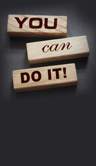 YOU CAN DO IT word on wooden blocks on gray background. Motivation affirmation encouraging words...