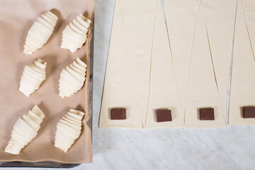 Fototapeta na wymiar Puff pastry products. Making croissants with chocolate. Raw croissants with copy space.