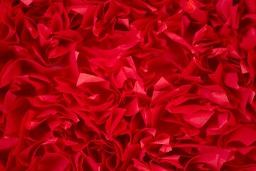 Red paper texture background. Macro of curved sheets of paper. Soft focus