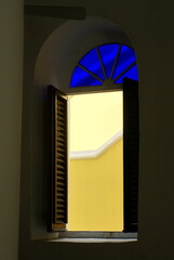 Window with blue glass and shutters in the Curacao Synagogue, Willemstad, Curacao